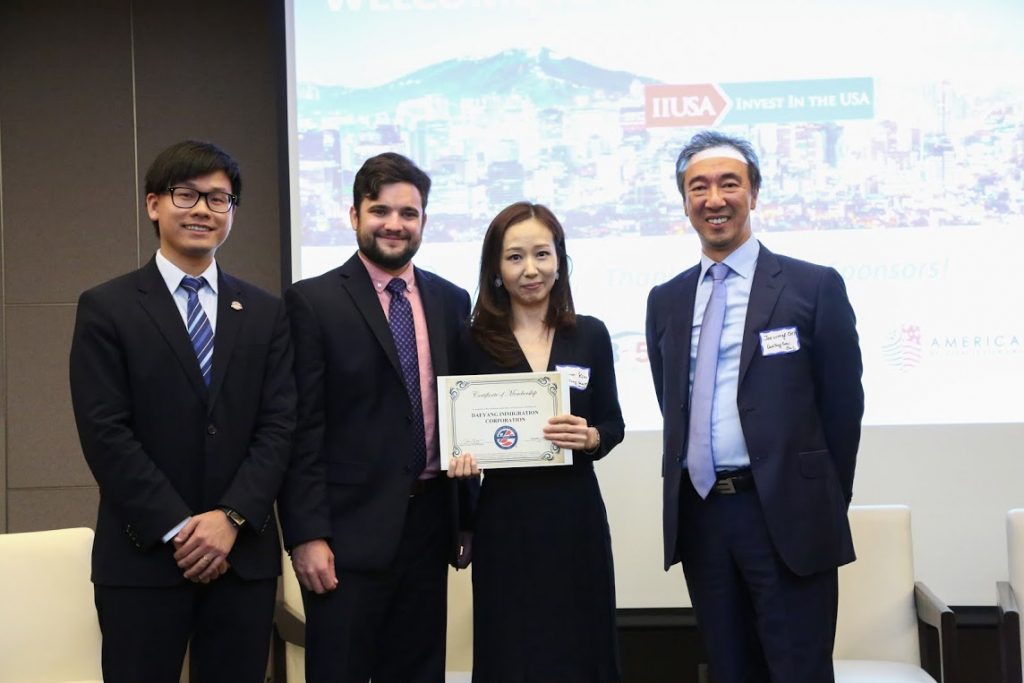 Representatives from DaeYang Immigration Corporation, a new IIUSA member, are presented their membership certificate by IIUSA Director of Events & Business Development McKenzie Penton and IIUSA Director of     Data Analytics Lee Li